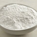 A bowl of white powder on a table.
