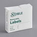 A white box of 500 Noble removable blank labels with green text.