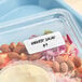 A plastic container with a removable blank label on a salad in a plastic container.