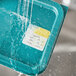 A blue container with water pouring over Noble Products Tuesday food labels.