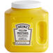 A yellow Heinz mustard jug with a white lid.