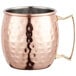 An Acopa Alchemy copper Moscow Mule mug with a hammered finish and a handle.