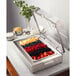 A Bon Chef rectangular stainless steel chafing dish with fruit in it.