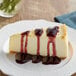 A slice of cheesecake with Capora Blueberry Flavoring Sauce on top.