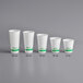 A row of white EcoChoice PLA paper cold cups with green text.