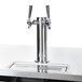 A metal tap with stainless steel accents on a counter.