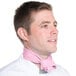 A man wearing a light pink Intedge chef neckerchief.