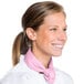 A woman in a white chef's coat wearing a light pink Intedge chef neckerchief.