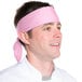 A man wearing a light pink Intedge chef neckerchief.