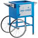 A blue and white Carnival King cart for snow cone machines with wheels.