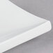 A close up of a CAC Tokyia bone white rectangular porcelain platter with curved edges.