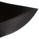 A black Fineline Wavetrends plastic serving bowl with a curved edge.