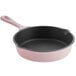 A pink enameled cast iron skillet with a handle.