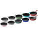 A row of Valor 6" Glacier enameled cast iron mini skillets in blue, green, and black.