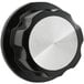 A black and silver control knob with a round metal plate.
