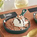A Valor green enameled mini cast iron skillet with brownie, ice cream, and nuts.