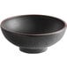 A black stoneware bowl with a red rim.