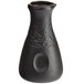 A close-up of a black Acopa stoneware sake bottle with a round neck.