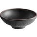 A black stoneware bowl with a brown rim.