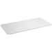 A white rectangular polyethylene cutting board insert for Regency wire shelving.