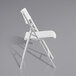 A National Public Seating AirFlex white folding chair with a white backrest.