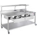 A stainless steel Avalon Manufacturing donut finishing table with two drawers.