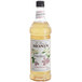 A Monin bottle of Elderflower Flavoring Syrup with a label.