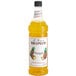 A 1 liter bottle of Monin pineapple syrup.