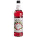 A Monin bottle of cranberry syrup with red liquid inside.