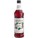A Monin Premium Raspberry Fruit Syrup bottle.