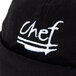 A black Chef Revival beanie with white text on it on a kitchen counter.