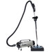 A MetroVac Professional Evolution canister vacuum with a hose attached to it.