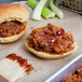 A close-up of two barbecue sandwiches with Cattlemen's BBQ sauce on a tray.