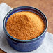 A blue bowl of Zatarain's Pro Boil orange powder.