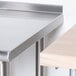 A stainless steel Advance Tabco filler table on a counter.