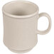 A close-up of a GET Sandstone white coffee mug with a handle.