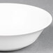 A Homer Laughlin bright white china bowl with a white rim on a grey surface.