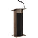 An Oklahoma Sound ribbonwood podium with a microphone.