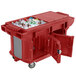 A red Cambro Versa Ultra work table with ice and drinks inside.