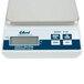An Edlund digital scale with a white surface, black and silver scale, and a screen showing numbers.