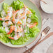 A plate of shrimp and lettuce with Zatarain's New Orleans Style Horseradish sauce.