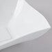 A white square plastic serving bowl with a wavy edge.