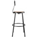A black lab stool with a round wooden seat.