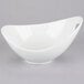 A white bowl with cut outs on a white background.