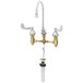A T&S deck mounted medical faucet with 4" wrist action handles and a gooseneck spout.