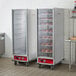 An Avantco heated holding cabinet with a clear glass door displaying bread.