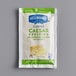 A small white Hellmann's Creamy Caesar dressing packet with green text.