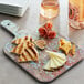 A rectangular American Metalcraft faux reclaimed wood melamine serving board with cheese, meat, and figs on it.