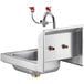A Regency stainless steel wall mounted hand sink with two faucets.