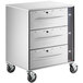 A stainless steel ServIt mobile cabinet with three drawers and black wheels.